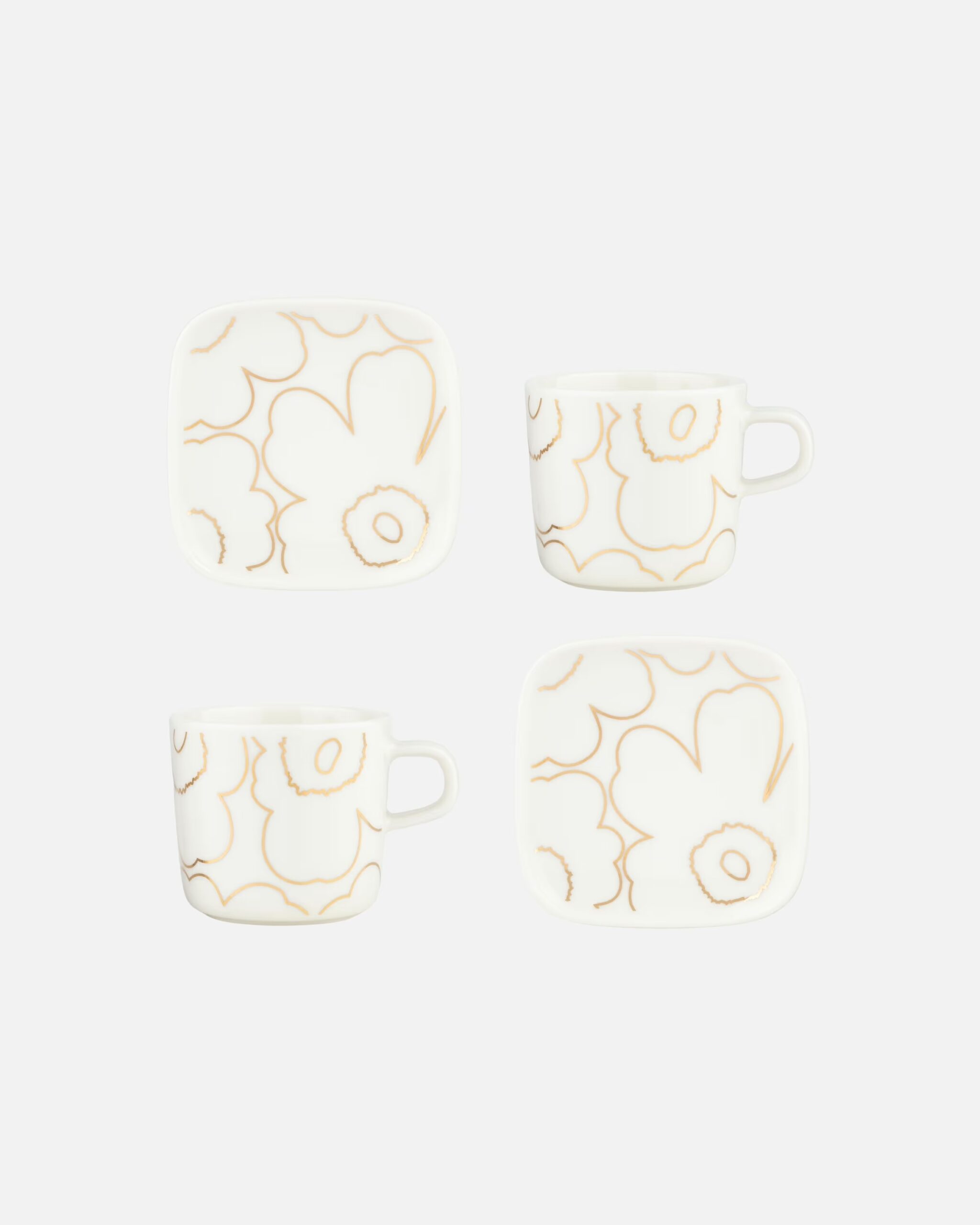 Dieses Set enthält zwei 2-dl-Oiva-Kaffeetassen und zwei kleine Oiva-Teller die mit dem goldenen Piirto-Unikko-Muster bedruckt sind.
